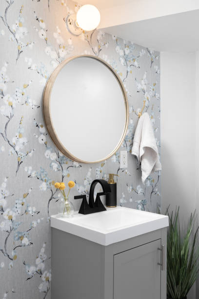 istock A bathroom with wallpaper and grey cabinet. 1469195372