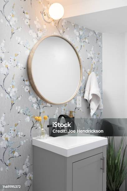 A Bathroom With Wallpaper And Grey Cabinet Stock Photo - Download Image Now - Bathroom, Apartment, Bathtub