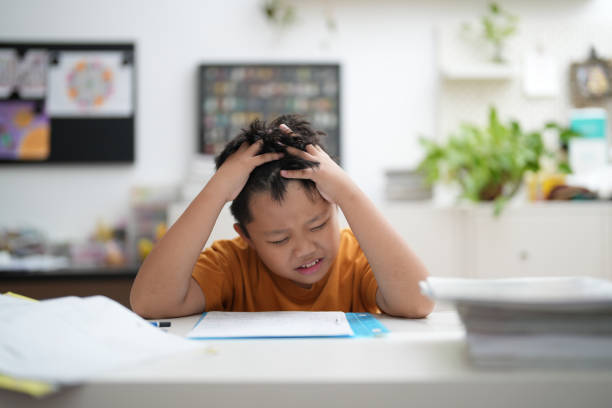 istock Worried young school boy studying at home 1469195796