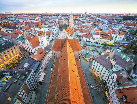 A view over Peterskirche's rooftop and the Munich cityscape stretching to the horizon.