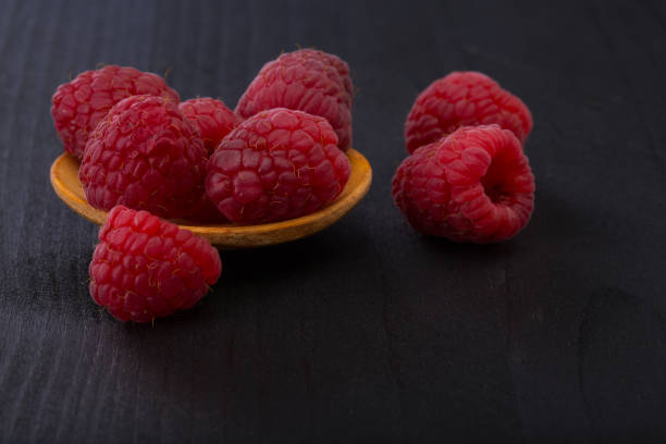istock Fresh raspberry in a wooden plate 1469199508