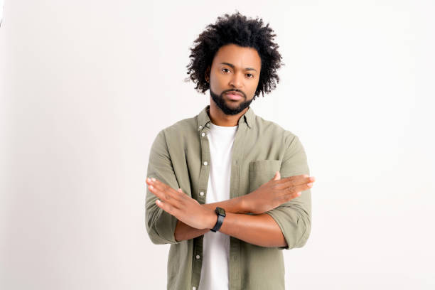 istock Serious African-American young man is showing stop gesture isolated on white background 1469199519