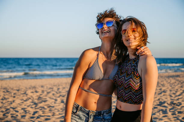 istock Young Lesbian Couple Embracing On The Beach 1469200075
