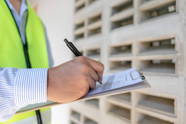 istock inspector or engineer is inspecting construction and quality assurance new house using a checklist. Engineers or architects or contactor work to build the house before handing it over to the homeowner 1469200673