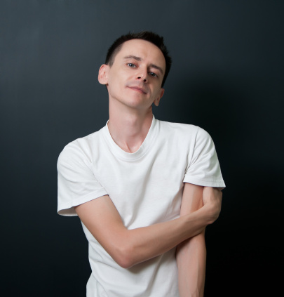 Studio portrait of a young man in white t-shirt.