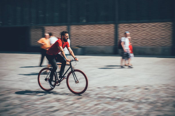 istock Young bearded man riding a Fixed Gear Bicycle on a Street 1469202513