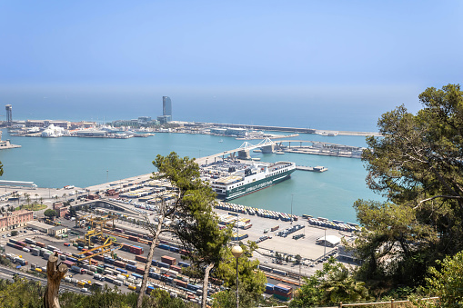 Barcelona, Spain - July 21, 2022: The cargo terminal with moored ship and containers.