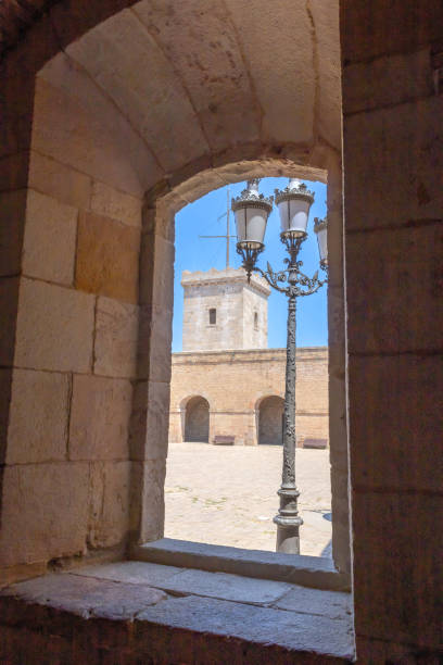 A view of the inner courtyard of Montjuic Castle through the arched window stock photo