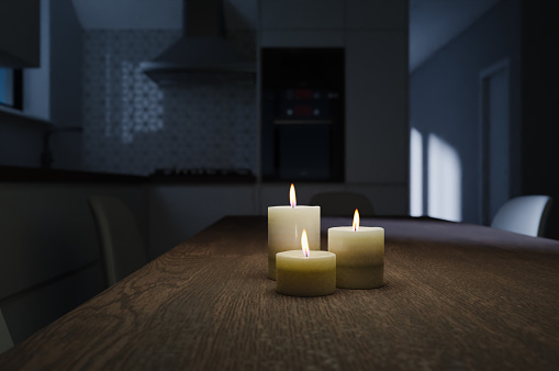 Generic kitchen interior at night with moon light and burning candles in 3d rendering. Digital illustration of contemporary dining room at home, mock up with copy space