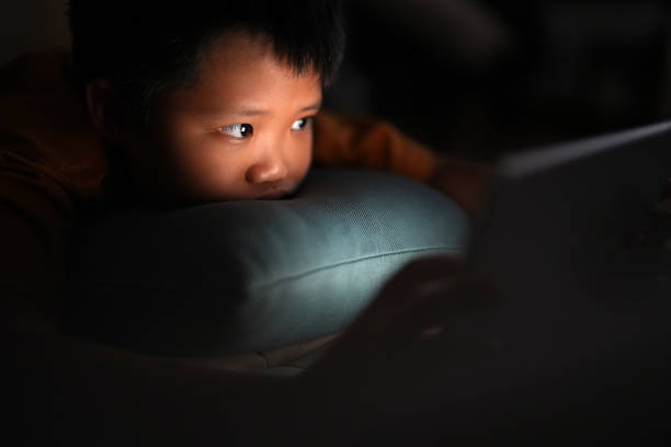 istock Young boy using a digital tablet at home at nighttime 1469204935