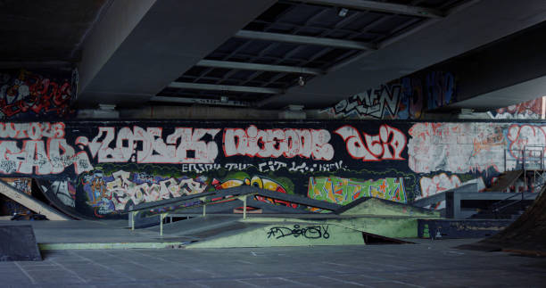 istock Skate park with artistic graffiti wall. Urban training area with rail and ramp. 1469205784