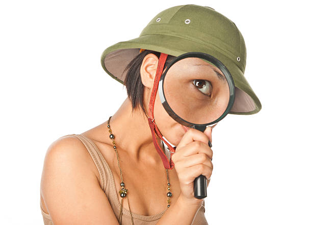 istock Girl in a pith helmet looks throught magnifier 146920639
