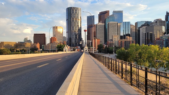 Calgarys skyline with its skyscrapers and office buildings. Bow river and centre Street Bridge in the foreground. Alberta - Canada