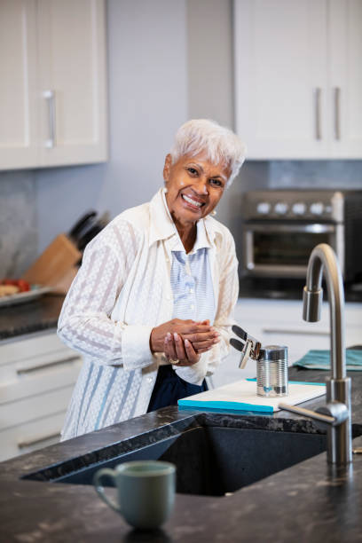 istock Senior woman in kitchen, with arthritis in her hands 1469207982