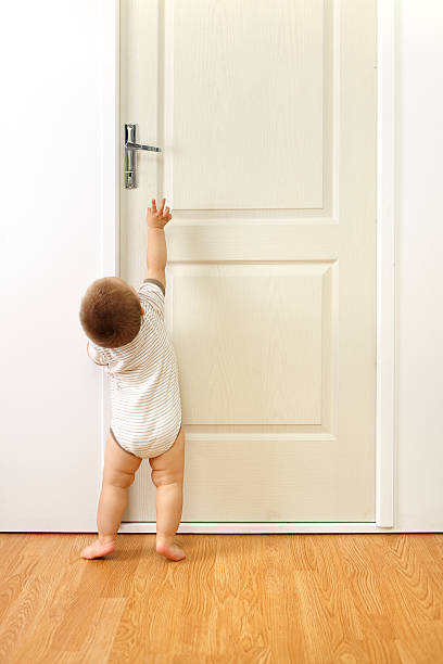 istock Baby boy in front of door 146920824