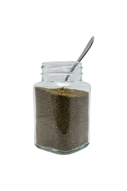 istock Celery seeds in a glass jar with the spoon. Isolated on white with clipping path. 1469208476