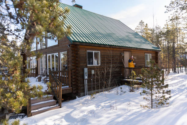 istock Man drinking coffee on the porch at a cabin. 1469208724