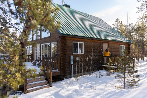 istock Man drinking coffee on the porch at a cabin. 1469208729