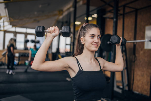 istock Woman exercising with dumbbells 1469209018