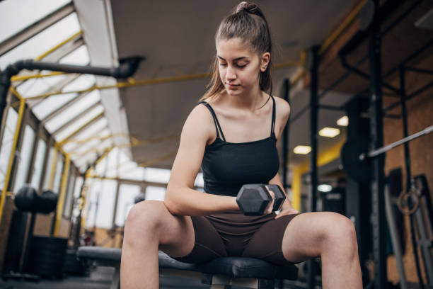 istock Woman exercising with dumbbell 1469209178