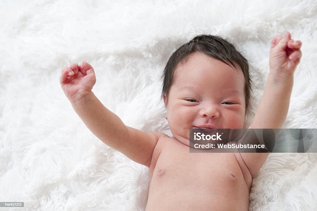 Happy newborn baby Happy newborn baby with arms up in the air. Waking up Stock Photo