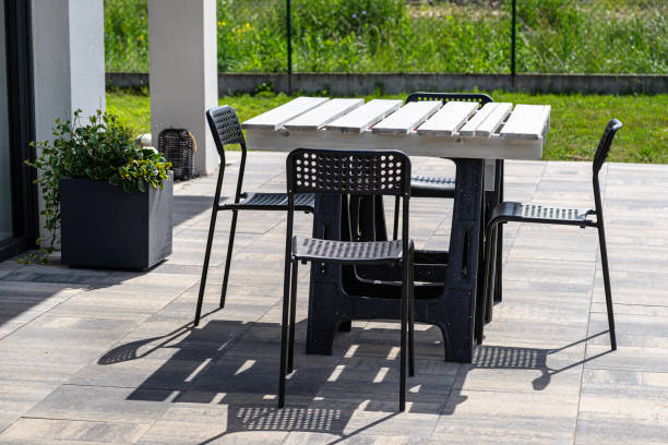 istock Terrace table made of white pallet standing on plastic trestles, black plastic chairs. 1469212470