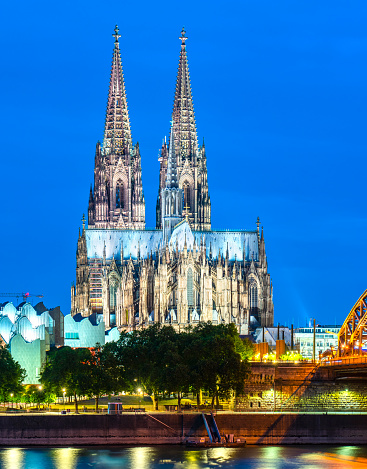 The Cologne Cathedral and Rhine river at night.