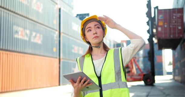 istock Professional woman engineer worker wearing hard hat and using digital tablet rechecks inventory walks in the warehouse 1469213093