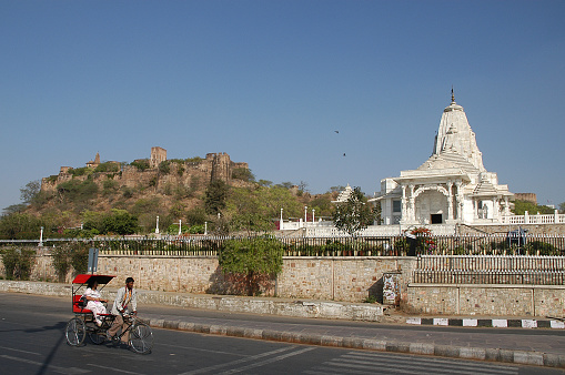 Rajasthan, India - February 24, 2006: Scene with rickshaw in a central avenue in front of the Birla Mandir Temple in the city of Jaipur