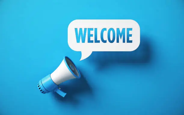 Welcome Written Speech Bubble and Blue Megaphone on Blue Background