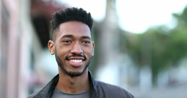istock Mixed race young man walking outside in sidewalk. Confident black African guy 1469215743