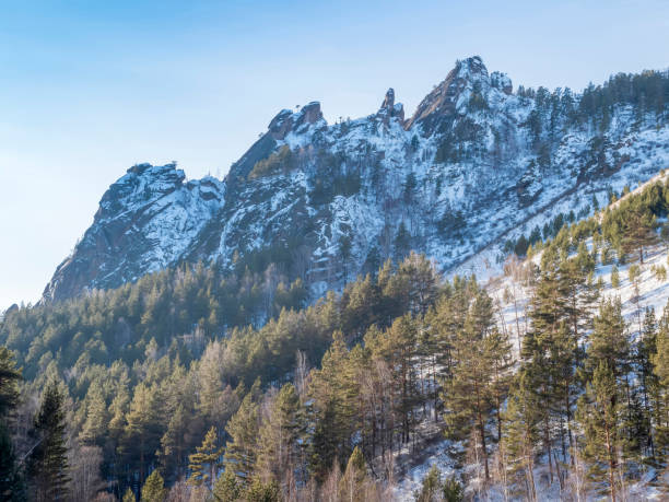 istock High rock formations surrounded by forests covered snow. 1469216568