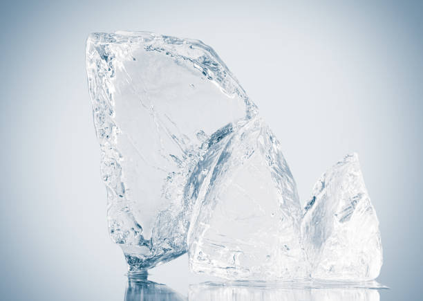 istock A pieces of natural textured clear blue crushed ice with cracks on a white reflective surface. 1469217787