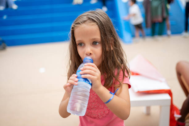 istock Child drink water from plastic bottle outdoor 1469218901