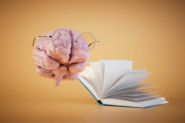 istock the concept of continuous learning. brain in glasses next to an open book on a pastel background. 3D render 1469219742