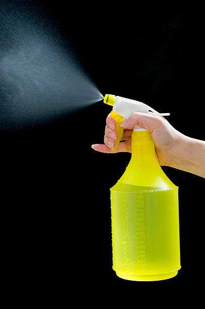 istock Female Hand Grabbing Yellow Spray Bottle 146922387