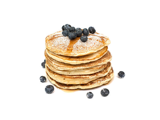 Pancakes A stack of pancakes with blueberries, powdered sugar and syrup. Isolated on white background. pancake stock pictures, royalty-free photos & images