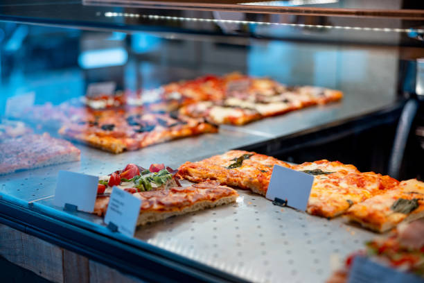 istock Pizza in rectangular shape, various types of toppings and tastes in take out showcase 1469230905