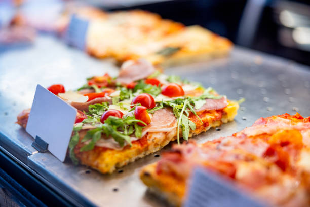 istock Pizza with cherry tomato and arugula on top, in rectangular shape in take out show case 1469231083