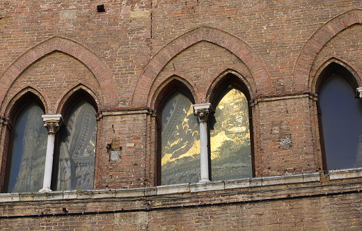 reflections in the old Windows called Bifore in the old medieval Italian palace without people