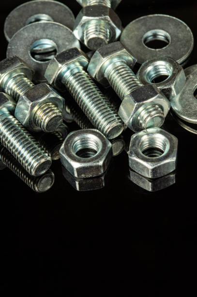 istock Metal bolts and nuts on a black isolated background 1469233663