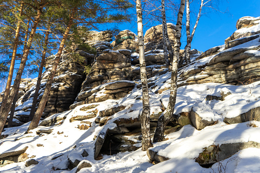 Small Devils Rock, Devil's Hillfort or  Devil's Settlement or Mound or City complex on sunny, cloudless winter day. Iset Park, Iset village, Sverdlovsk region, Russia. Hiking.