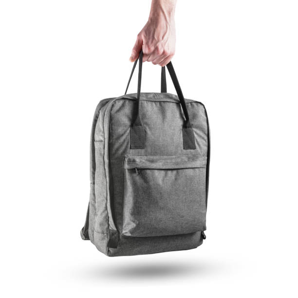 istock Grey casual backpack in the human hand. Fabric rucksack with handles front view. 1469235907