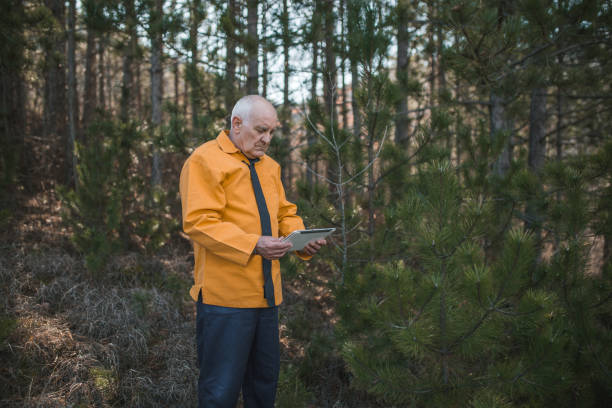 istock A senior man explores a pine forest using the internet and a digital tablet in a remote location 1469236066