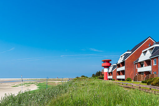 Beach and buildings in Wittduen on the island Amrum, Germany.