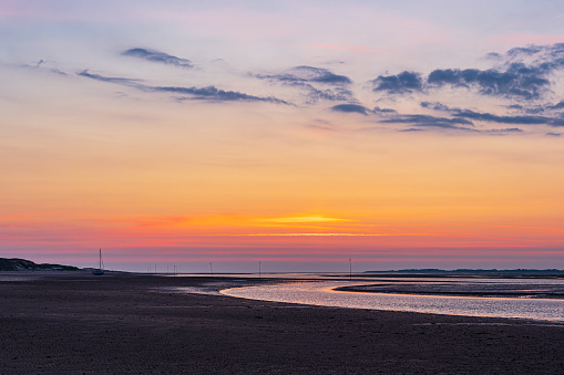 Mud flat with sunrise on the island Amrum, Germany