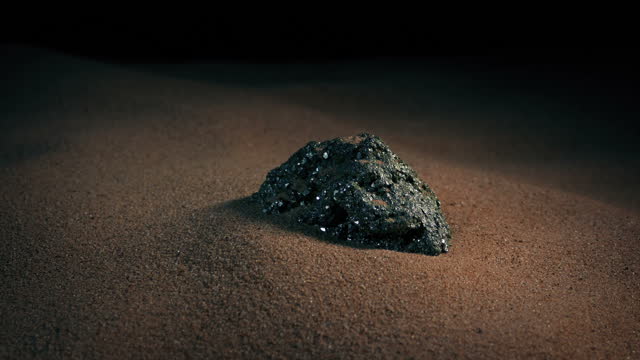 Metal Ore In The Sand Circling Shot