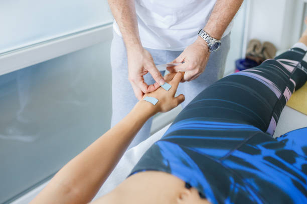istock Applying electrodes on patient's hand for electronic stimulation 1469238848