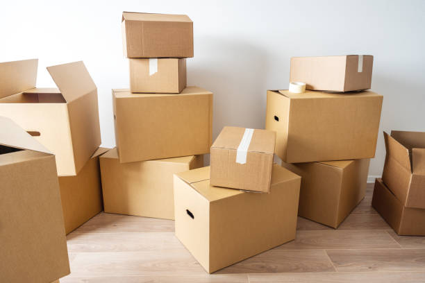 istock Stack of cardboard boxes at empty residential apartment. Moving home concept 1469245730