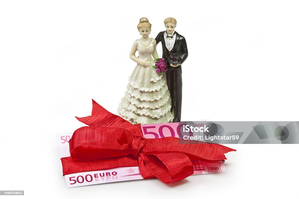 Wedding present Bridal couple and  fivehundred Euro banknote wrapped with red ribbon as a gift European Union Currency Stock Photo